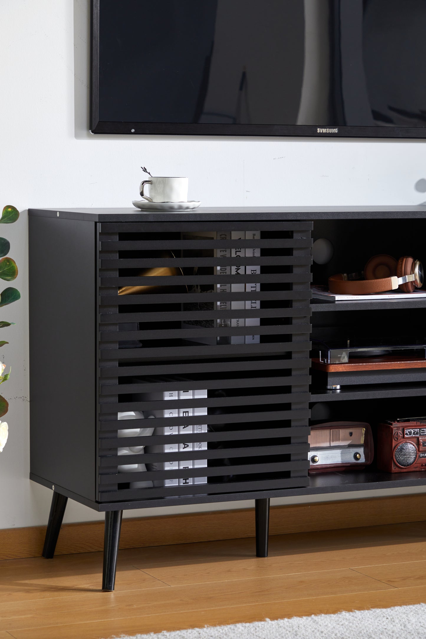 Mid-Century Black TV Stand with Hollow Doors and Storage Shelves for TVs up to 60