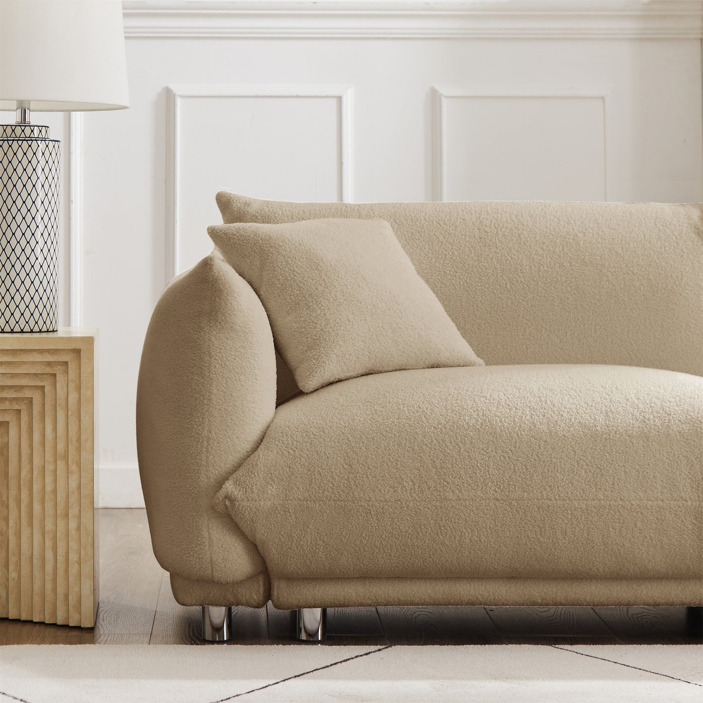 A lovable, fat, bread-like sofa with 2 pillows and metal feet with anti-skid pads