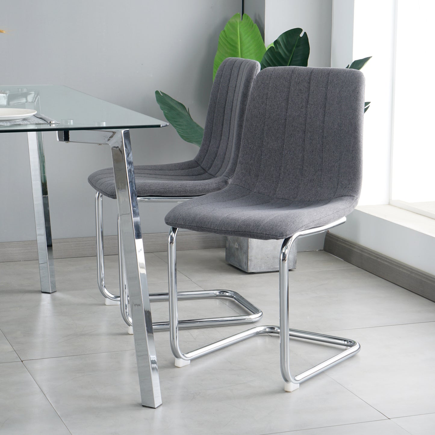 51.1" Table and chair set, one table and four chairs. Clear tempered glass table top, 0.3" thick, silver metal legs. fabric chair with electroplated metal legs.